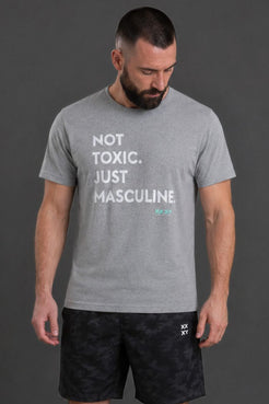 Man wearing a gray t-shirt with text and black shorts on a dark background || Light Heather Gray
