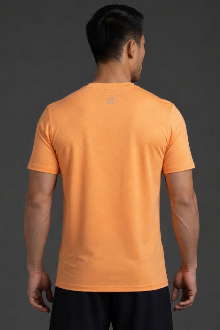 Person wearing an orange t-shirt on a gray background