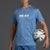 Person wearing a blue 'XX-XY Athletics' t-shirt and shorts, holding a soccer ball on a gray background || Cobalt Blue