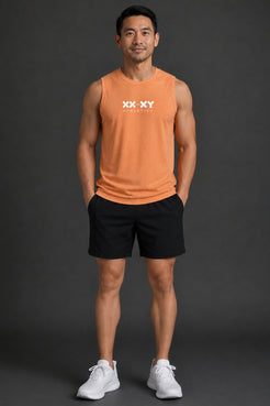 Man wearing an orange tank top with a logo and black shorts on a dark background || Light Orange
