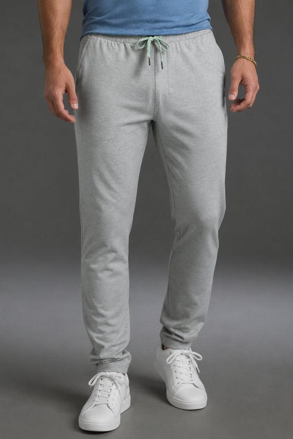 Person wearing gray sweatpants and white sneakers on a gray background || Light Heather Gray - 1