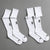 Two pairs of white socks with black branding on a gray background || White