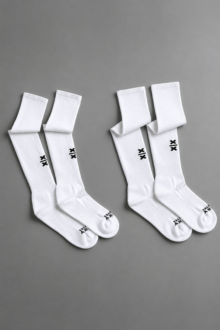 Two pairs of white socks with black branding on a gray background