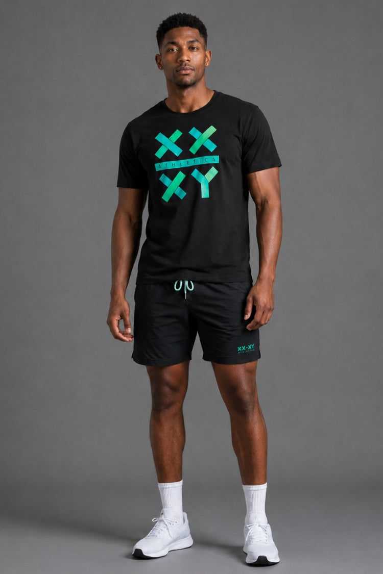 A man modeling a black athletic t-shirt and matching shorts set. The t-shirt features a teal and green graphic on the chest with the letters 'XXXY' arranged in a grid.
