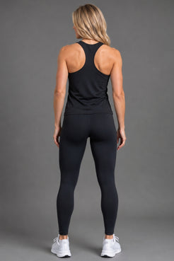 Woman wearing a black tank top and leggings with a logo || Black