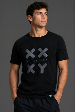 Person wearing a black t-shirt with a logo and text on a gray background || Black Tonal