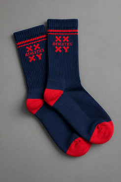 Pair of blue socks with red accents on a gray background || blue aster/red