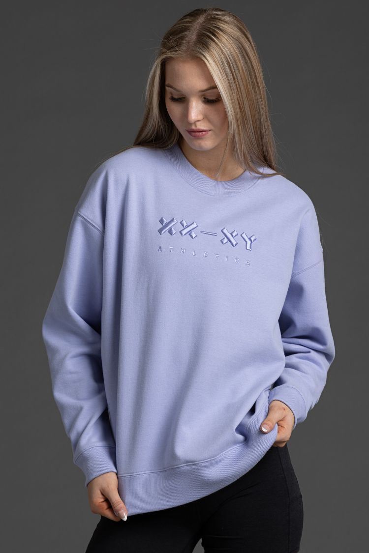 Woman wearing lavender sweatshirt with text on a gray background || Lavender Gray