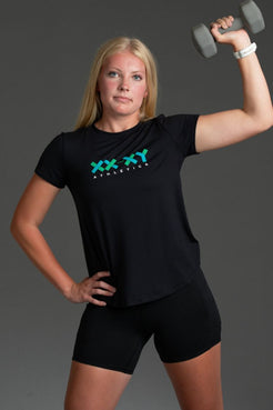 Woman lifting a dumbbell wearing a black t-shirt with a logo and black shorts || Black/Dark Heather Gray/White