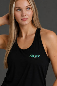 Close-up of woman wearing a black XX-XY Athletics performance tank with teal logo. || Black