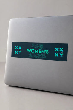 A rectangular bumper sticker with the text 'SAVE WOMEN'S SPORTS' in teal on a dark teal background, displayed on a gray laptop.