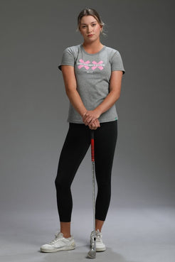 Woman holding a golf club against a gray background || Heather Gray