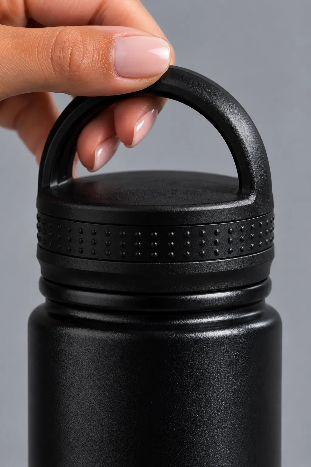 Close-up of the textured black loop lid on the XX-XY Athletics water bottle.