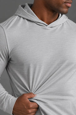 Close-up of the lightweight stretch fabric and texture of a light gray performance hoodie. || Light Heather Gray - 1