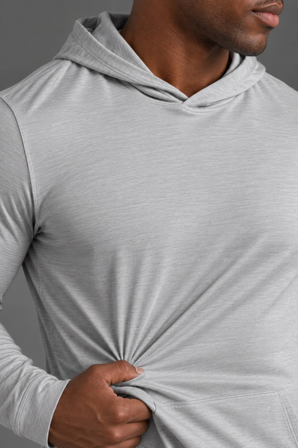 Close-up of the lightweight stretch fabric and texture of a light gray performance hoodie. || Light Heather Gray - 1