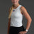 Woman wearing a white sleeveless top and black shorts on a gray background || White