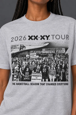 A white short-sleeve crewneck t-shirt featuring a black and white graphic print of a protest crowd with the text '2026 XX-XY TOUR' and 'THE BASKETBALL SEASON THAT CHANGED EVERYTHING'. The t-shirt is shown on a model, cropped from the neck down. || Light Heather Gray