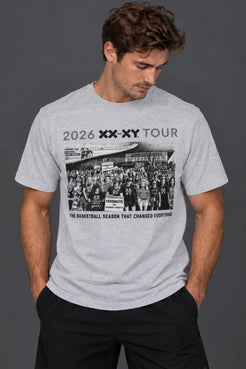 A man wearing a gray short-sleeve graphic t-shirt with a black and white basketball-themed print on the front, paired with black pants, against a dark gray studio background. || Light Heather Gray