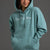 Person wearing a teal hoodie with 'Title X is Mine' text on a gray background || Underseas