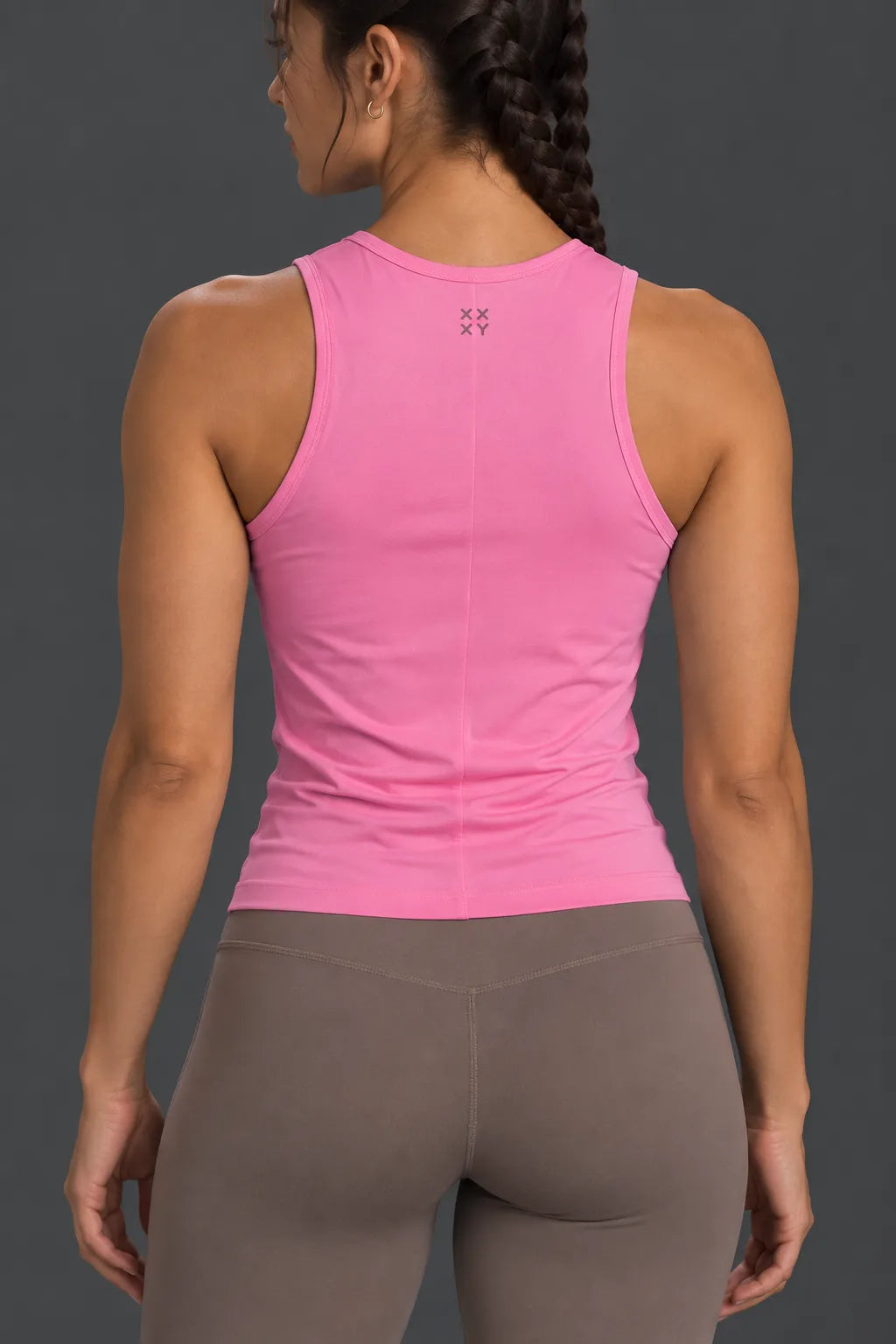 Back view of pink performance tank with XX-XY logo and mocha leggings.