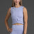 Woman wearing a Lavender athletic outfit on a dark background || Lavender Gray