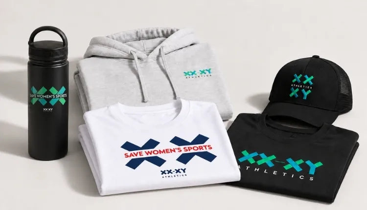 A coordinated apparel and accessory set on a light neutral background, including a black insulated water bottle, a folded light gray hoodie, a folded white T-shirt, a folded black T-shirt, and a black baseball cap. Each item features the XX-XY Athletics logo in teal and navy, with the slogan 'Save Women's Sports' printed on the front shirt.