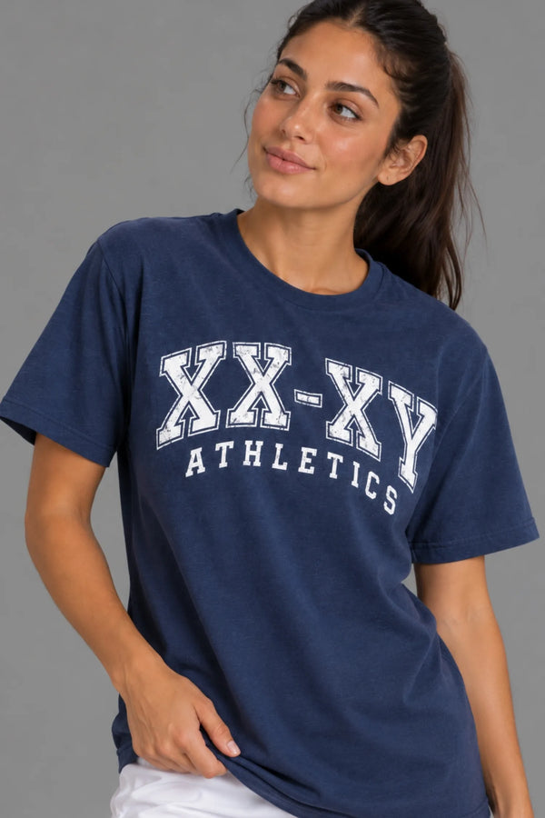 Close-up of female model wearing the XX-XY Athletics Varsity Logo Tee, highlighting the distressed white varsity graphic and navy cotton fabric || Navy
