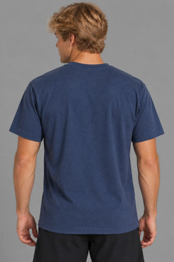 Male model showcasing the plain back of the XX-XY Athletics Varsity Logo Tee, paired with black shorts against a gray studio background || Navy