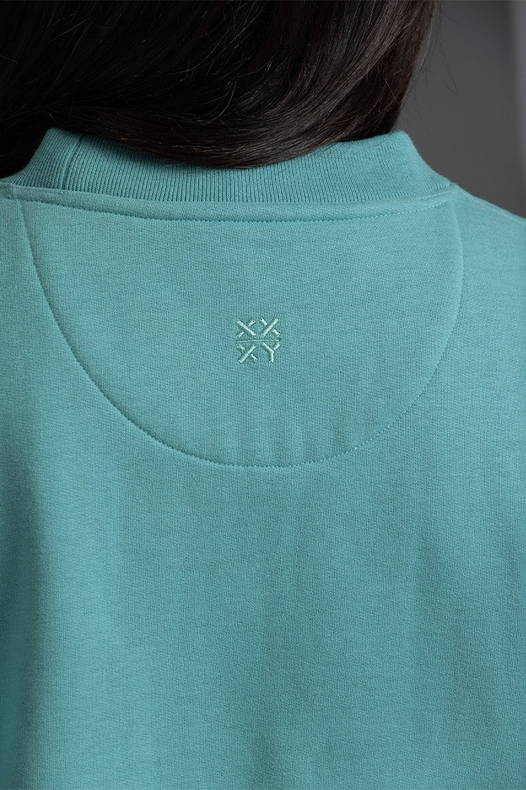 Teal sweatshirt with a logo on the chest area