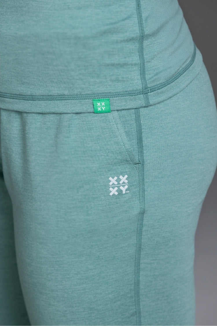 Teal leggings with a brand logo on a plain background