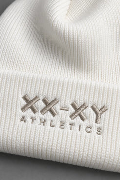 Close-up of white ribbed knit beanie highlighting the XX-XY Athletics embroidered logo and fabric texture || White