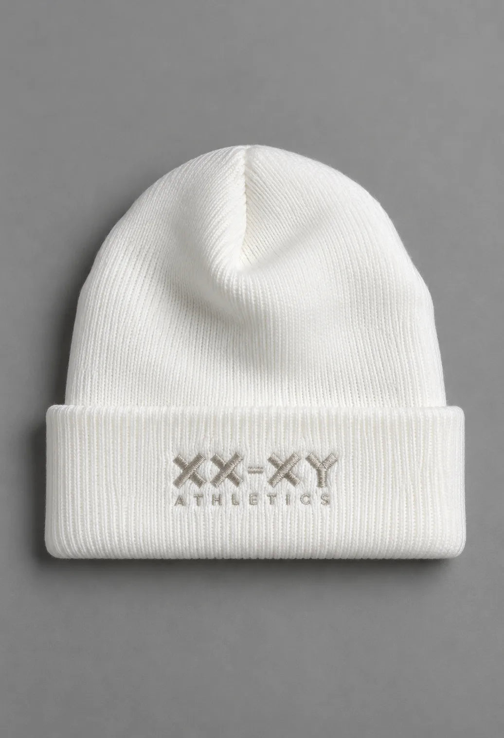 White ribbed knit beanie with folded cuff and embroidered XX-XY Athletics logo, front view || White