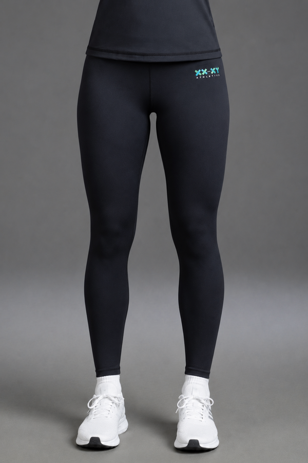 Person wearing black leggings with a logo and white sneakers  || Black