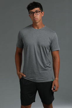 Man wearing a gray t-shirt and black shorts against a gray background || Dark Heather Gray/Black