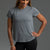 Woman wearing a gray t-shirt and black leggings against a gray background || Dark Heather Gray