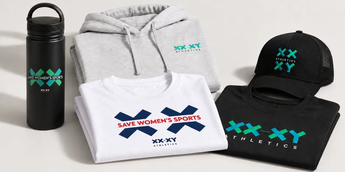 A coordinated apparel and accessory set displayed on a light neutral background, including a black insulated bottle, a folded light gray hoodie, a folded white T-shirt, a folded black T-shirt, and a black baseball cap. Each item features the XXXY Athletics logo in teal and the text 'SAVE WOMEN'S SPORTS' on the shirt graphics.