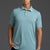 Man wearing a light blue polo shirt against a gray background || Underseas