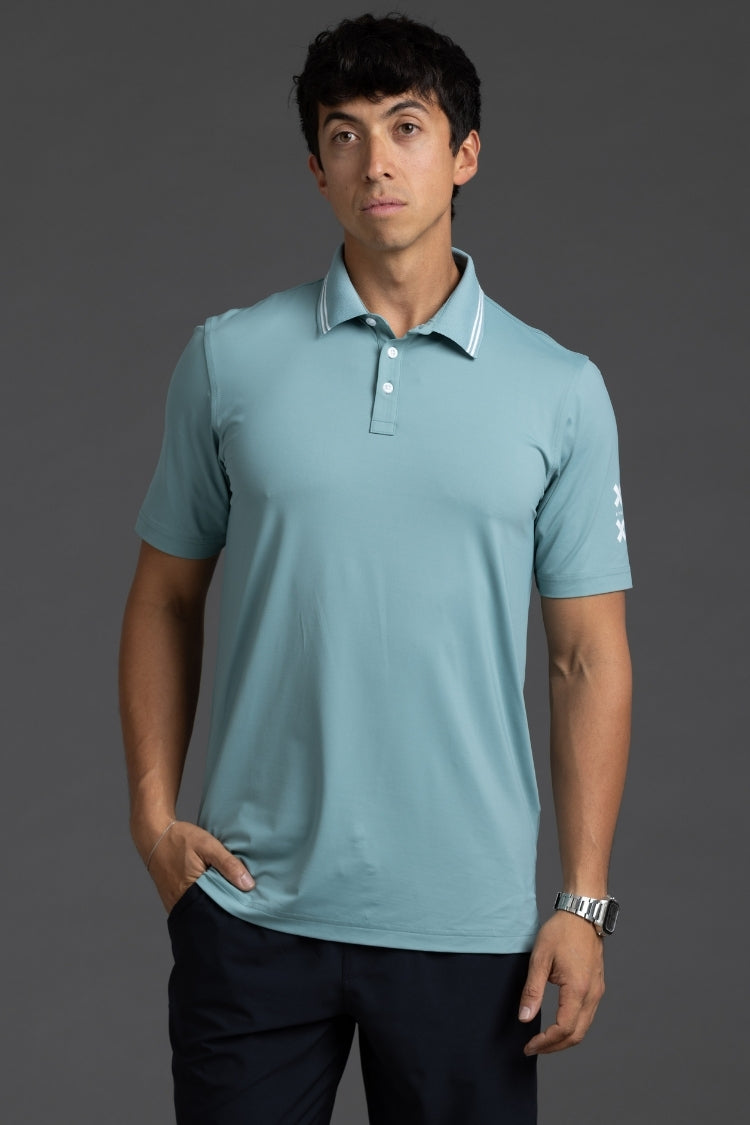 Man wearing a light blue polo shirt against a gray background || Underseas