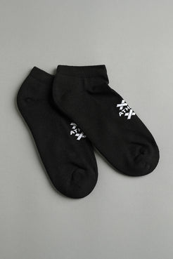 Two black ankle socks with white text on a gray background || Black