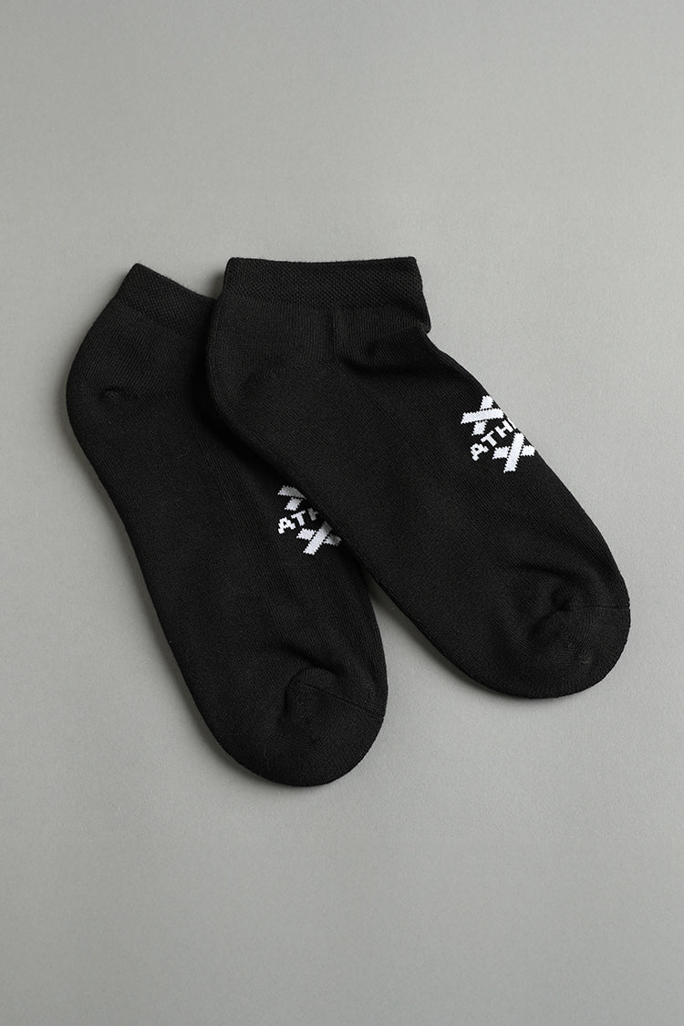 Two black ankle socks with white text on a gray background || Black
