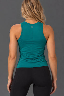 Back view of teal performance tank with XX-XY logo and black leggings. || Teal